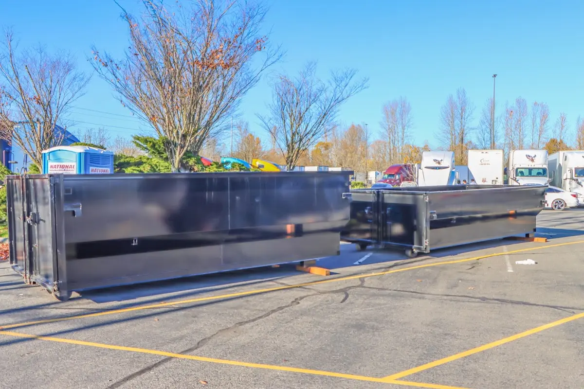 Professional dumpster rental service with roll-off container on residential driveway in Bakersfield